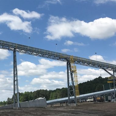 Industrial conveyor system with structural steel support for material handling plant