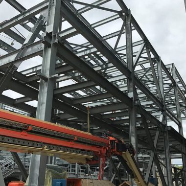 Structural steel building frame with beams and columns for industrial construction project