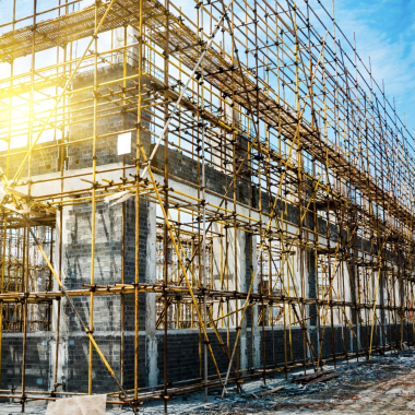 Building construction with scaffolding showing structural development and site execution