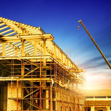 Structural steel building construction with crane and framework for industrial project